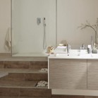 Ambiance avec une estrade dans la salle de bains, qui accueille douche et baignoire