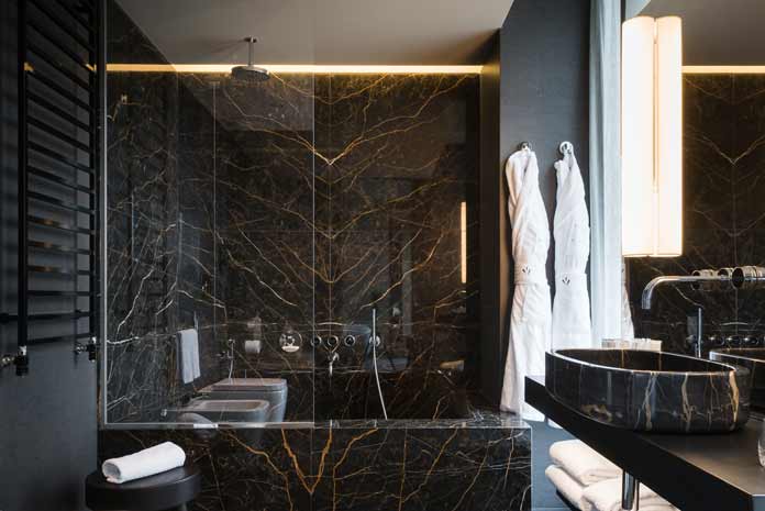 baignoire douche habillée de marbre noir veiné de marron