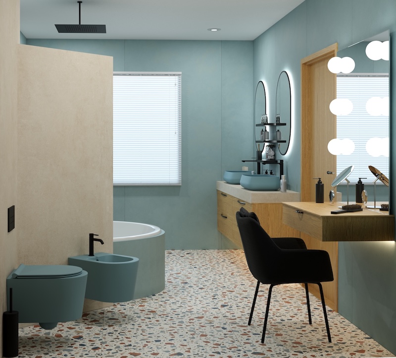Salle de bains avec WC et bidet, de couleur bleu.