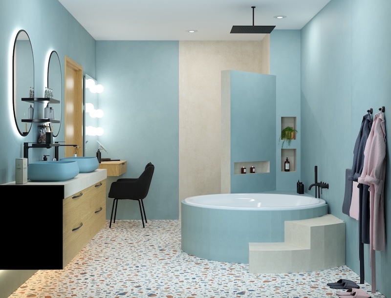 Une baignoire ronde bleue avec deux marches pour y accéder.